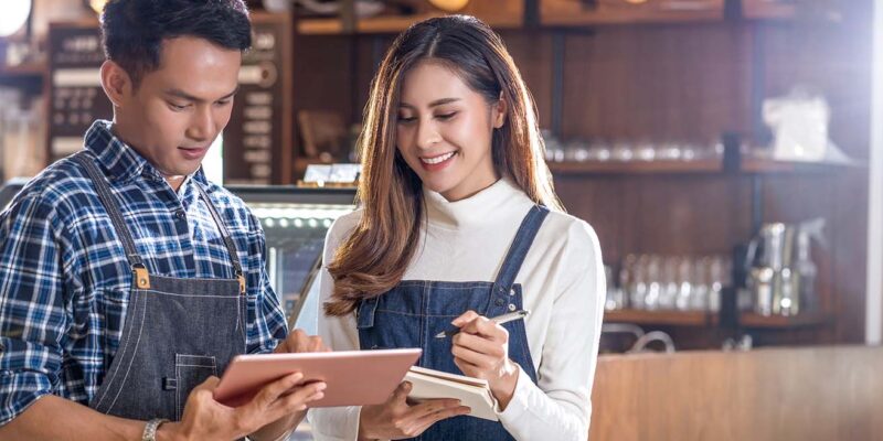 Asian couple working in their coffee shop