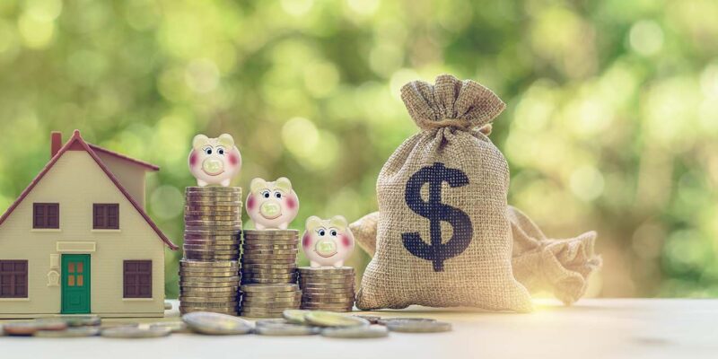 toy house with coins and bag of money