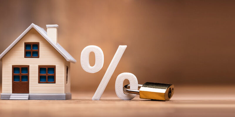 Toy house and percentage sign with lock on it