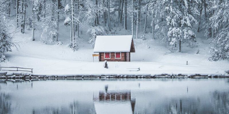 house on lake in winter