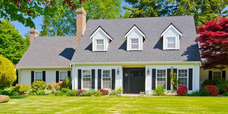 New england style house with green lawn