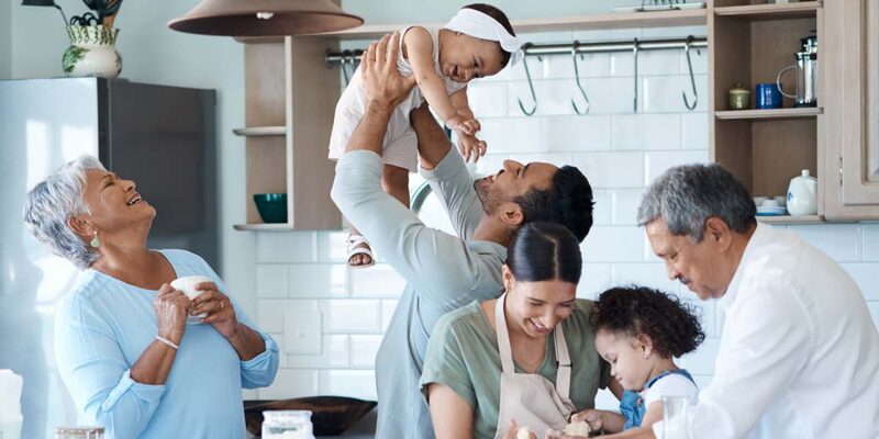 Three generations cooking together in a modern kitchen