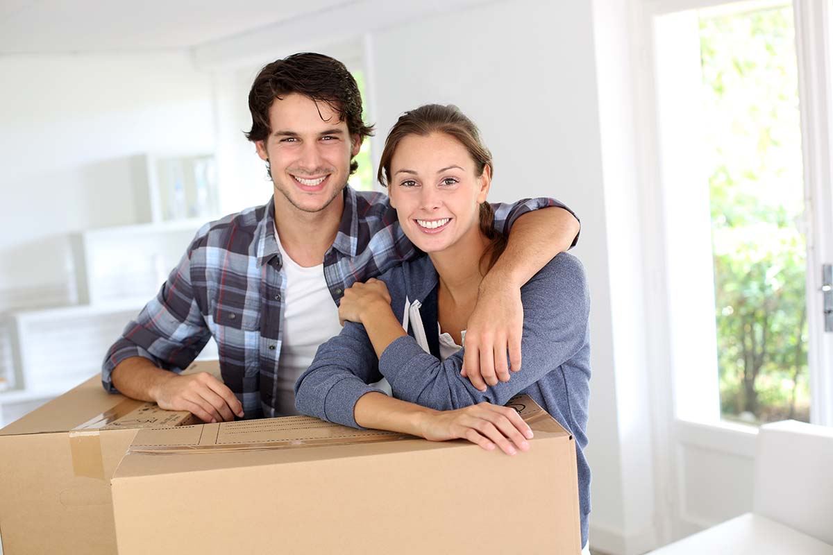 Happy homeowners with moving boxes
