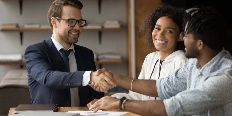 Loan officer shaking hands with clients