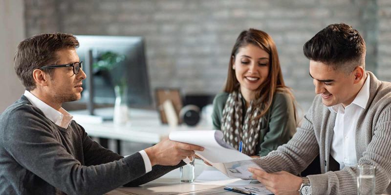 Young couple with loan officer