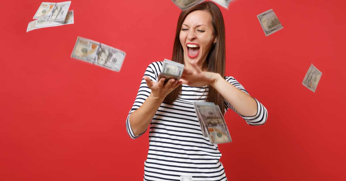 Woman with money blowing out of her hands