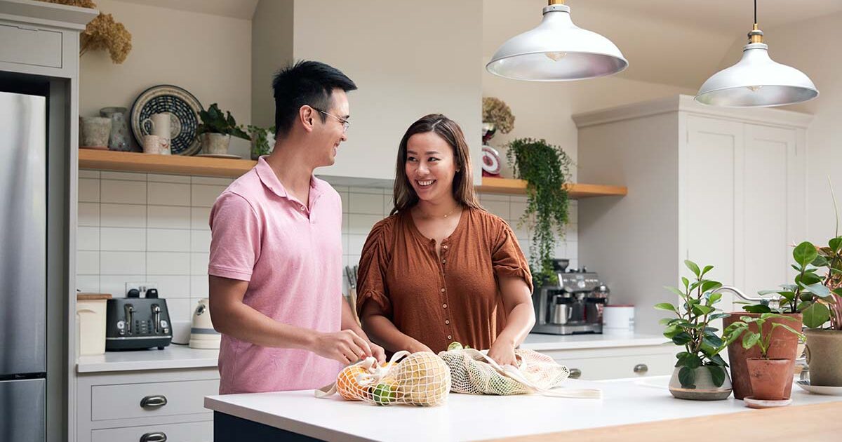 Young couple cooking together in their new home