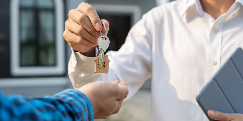 Realtor handing over house keys to buyer