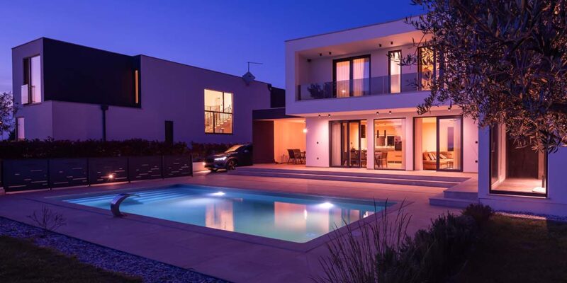 Luxury house with pool at night