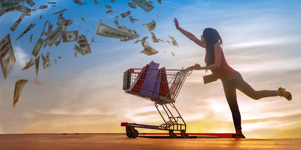 Woman with grocery cart chasing dollar bills