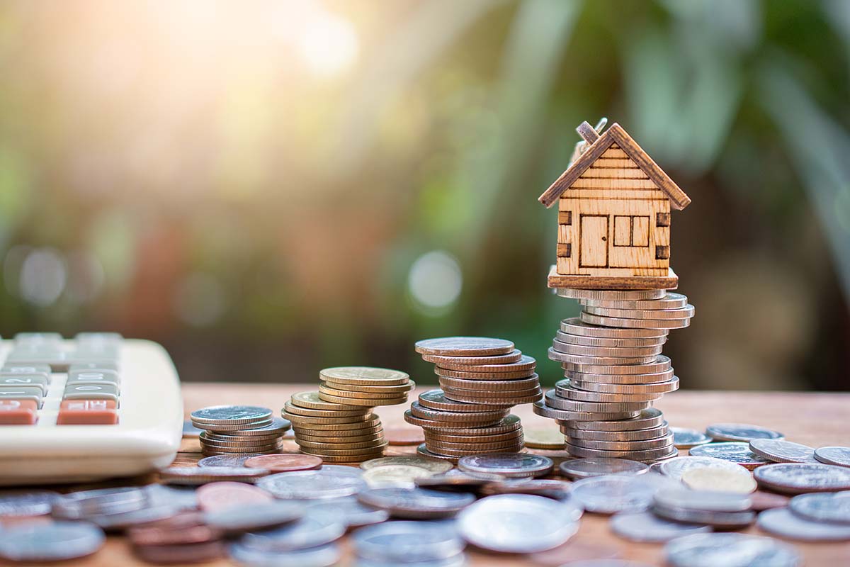 toy house with stack of coins