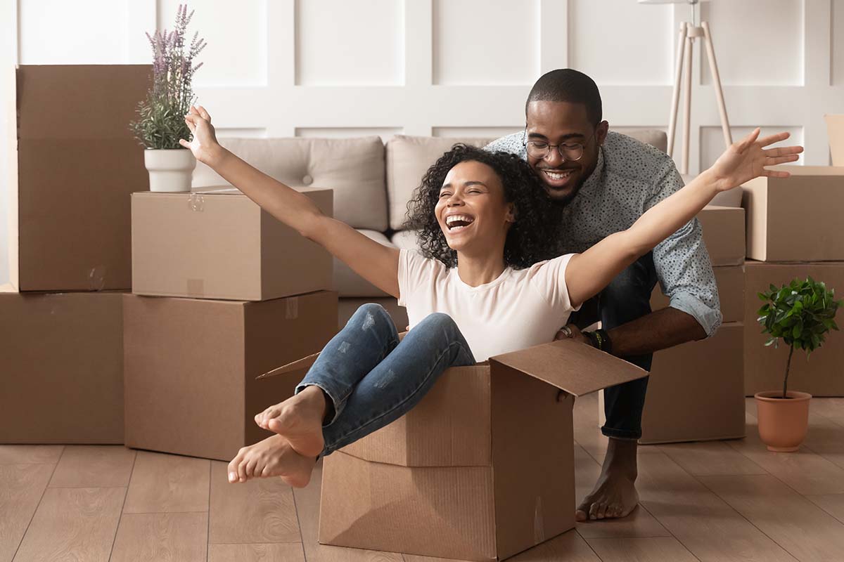 Happy homeowners with moving boxes