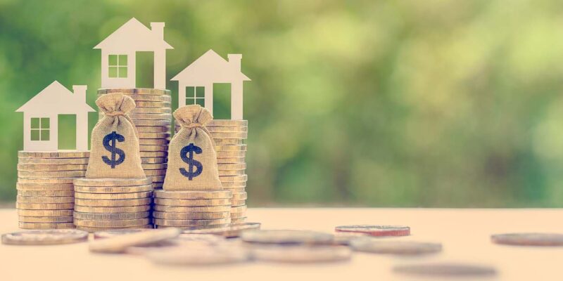 Conventional vs FHA loans coins and toy houses