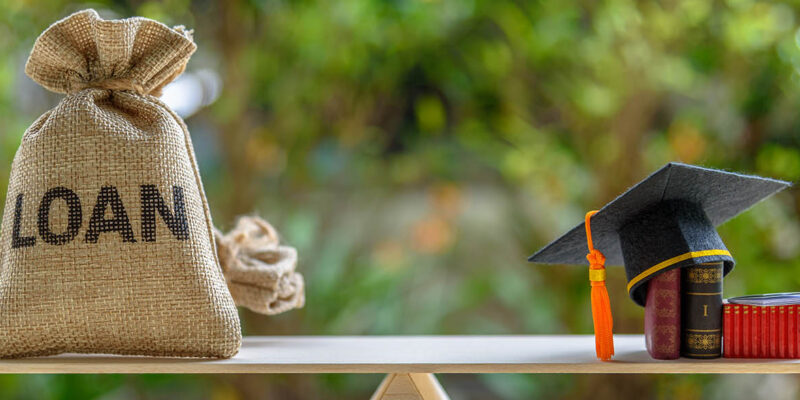 Scale with loan on one side and graduation camp on the other