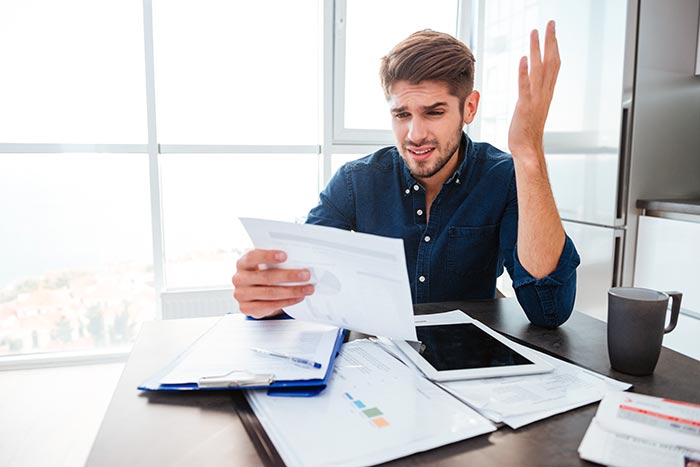 Man frustrated with paperwork