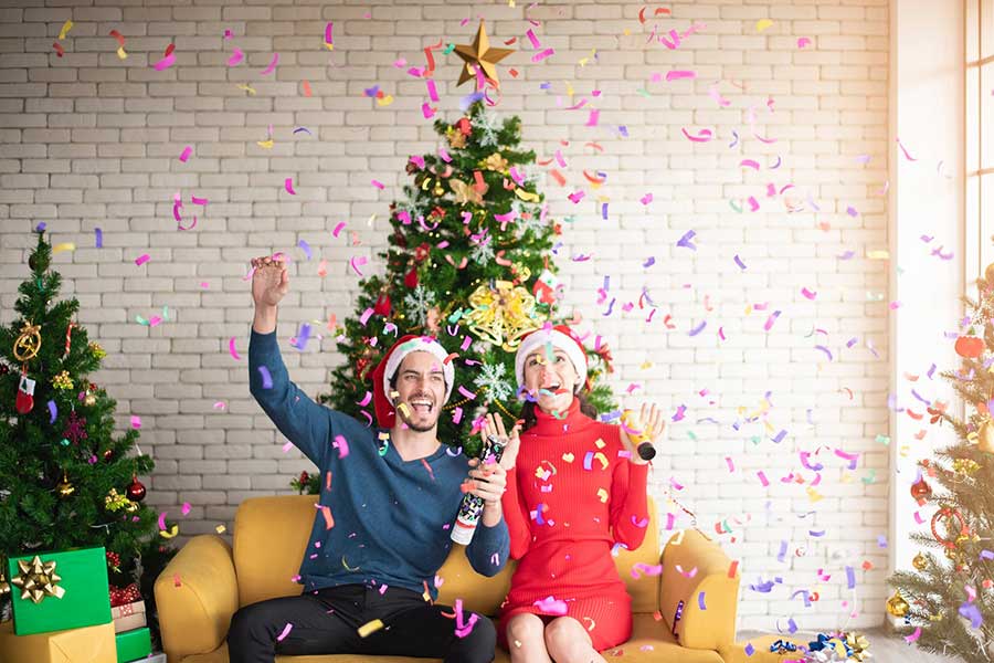 Christmas couple in front of tree