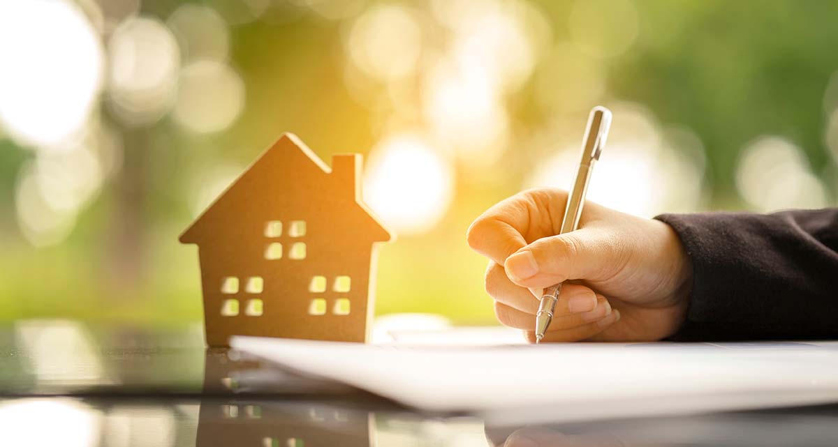 mortgage document signing with house icon