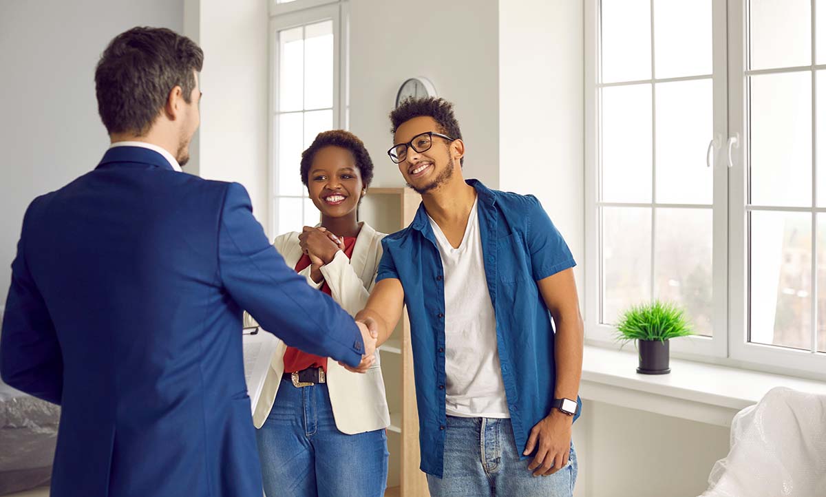 Young Couple Meeting Loan Officer Smiling