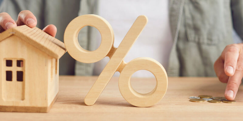 Toy House and Interest Rate with Hand Counting Money