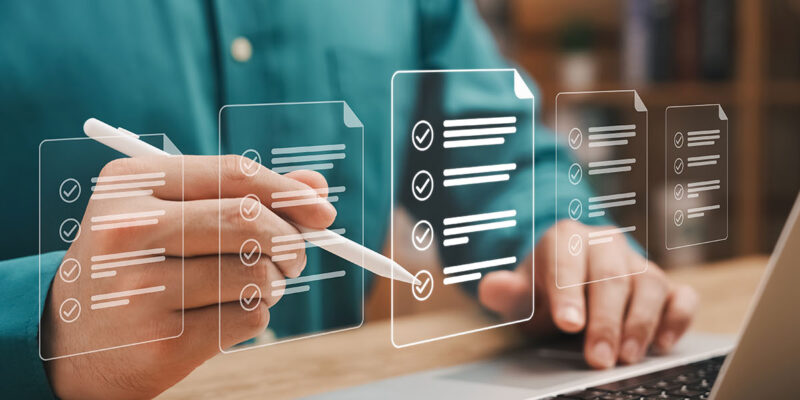 Hands in front of a computer screen checking boxes for mortgage application