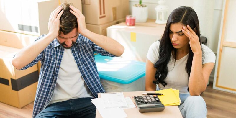 New homeowners stressed over budget with paperwork and calculator